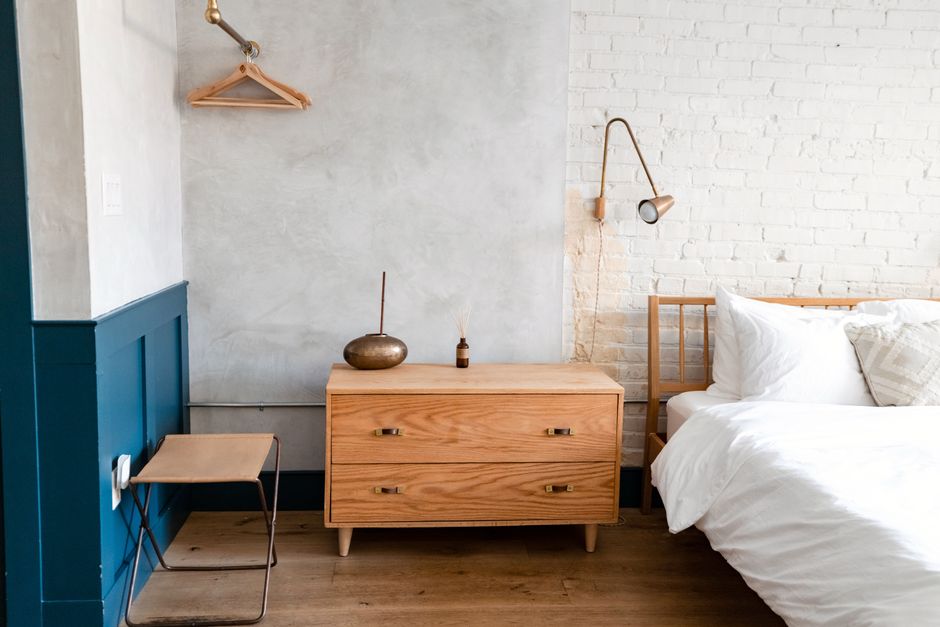 Contemporary bedroom with wooden furniture and white linens in Philadelphia.