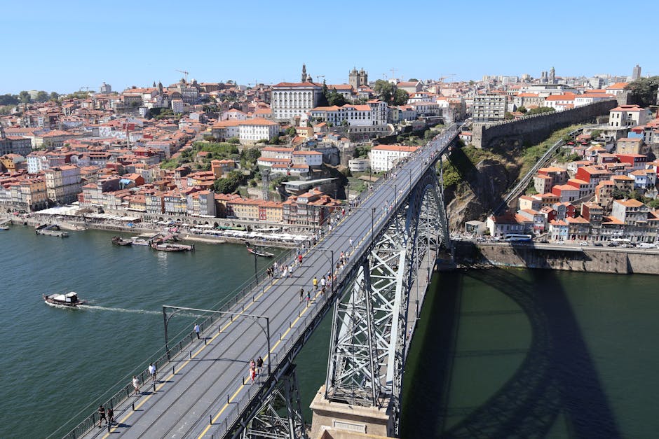 Stunning aerial view of Dom Luís I Bridge in Porto, showcasing the city's historical architecture and vibrant life.