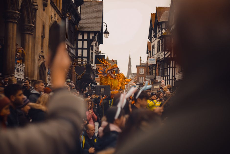 Vibrant festival parade with golden dragon in Chester, England.