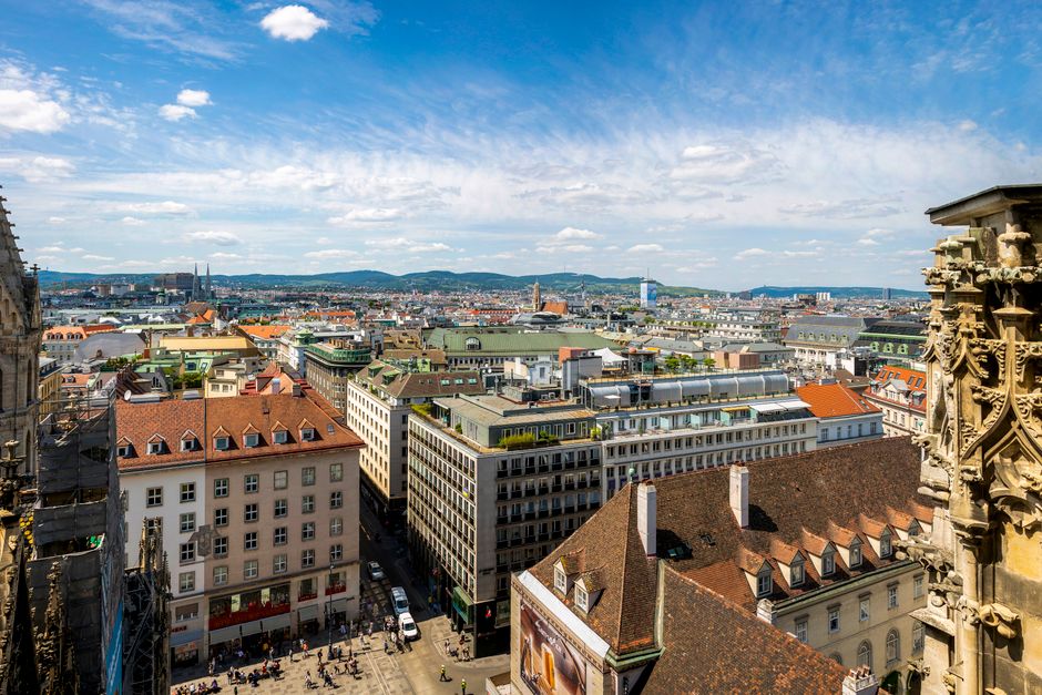 Stunning aerial view of Vienna showcasing urban architecture under a bright blue sky.