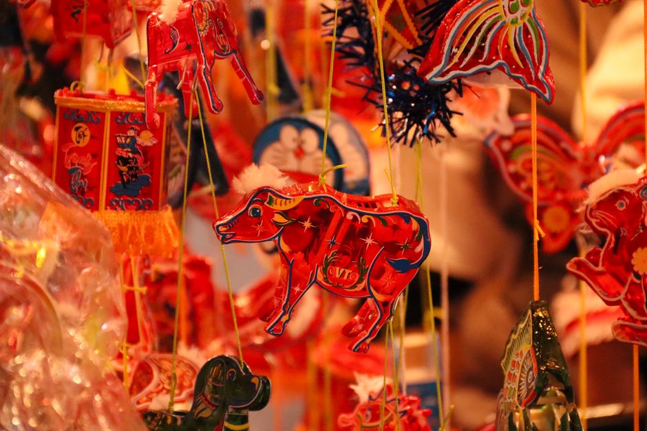 Vibrant red and gold traditional decorations at a Lunar New Year market, celebrating cultural festivities.
