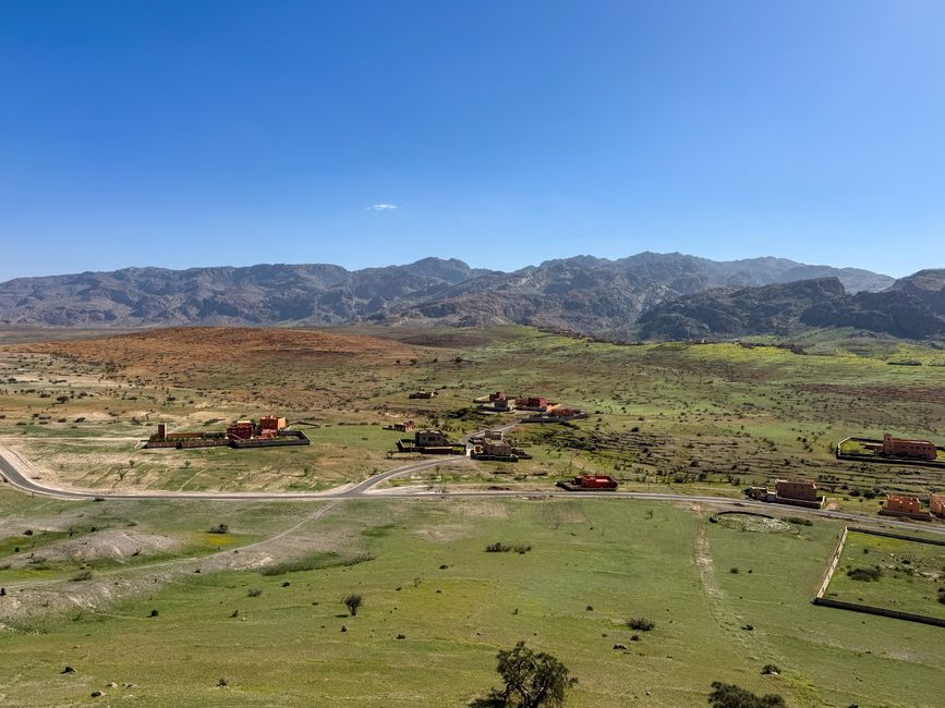 Panoramic landscape of Tizourgane, Morocco with mountains and rural buildings.
