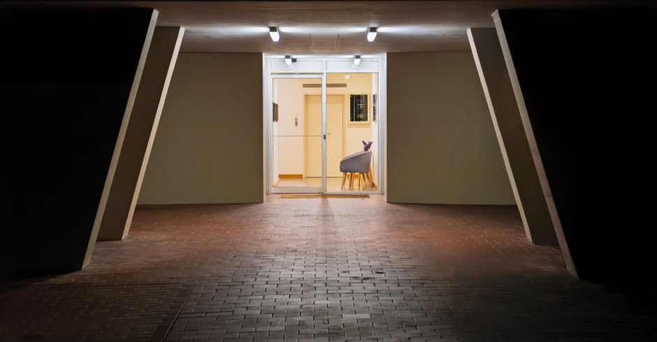 A contemporary building entrance in Hobart, Tasmania, illuminated at night.