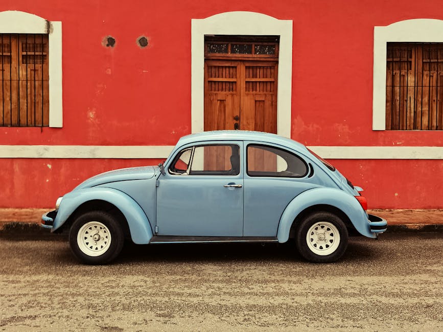 A classic blue Volkswagen Beetle parked on a colorful street in Cancún, Mexico.