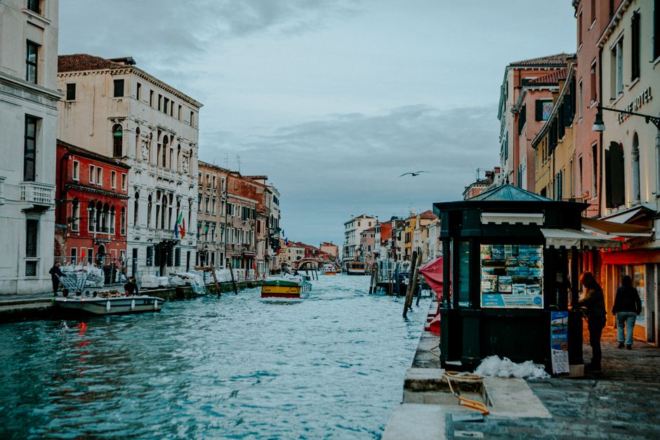 Charming view of Venice canal with boats and historic architecture, capturing the essence of Italian city life.