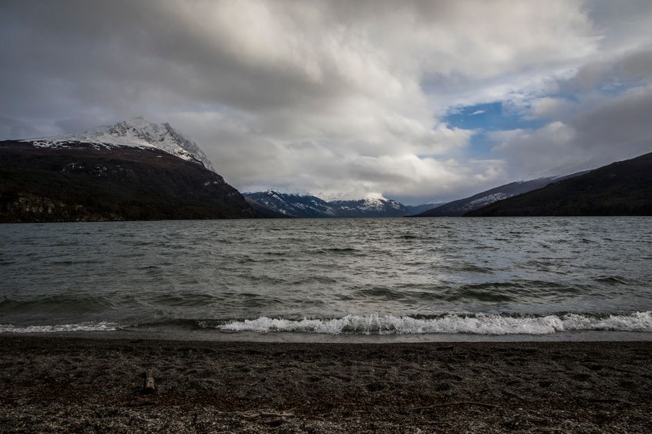 Wind-blown Patagonian lake below snowy mountains in Chile
